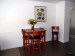 The dining area offers seating for 4 and is adjacent to the living room and kitchen.